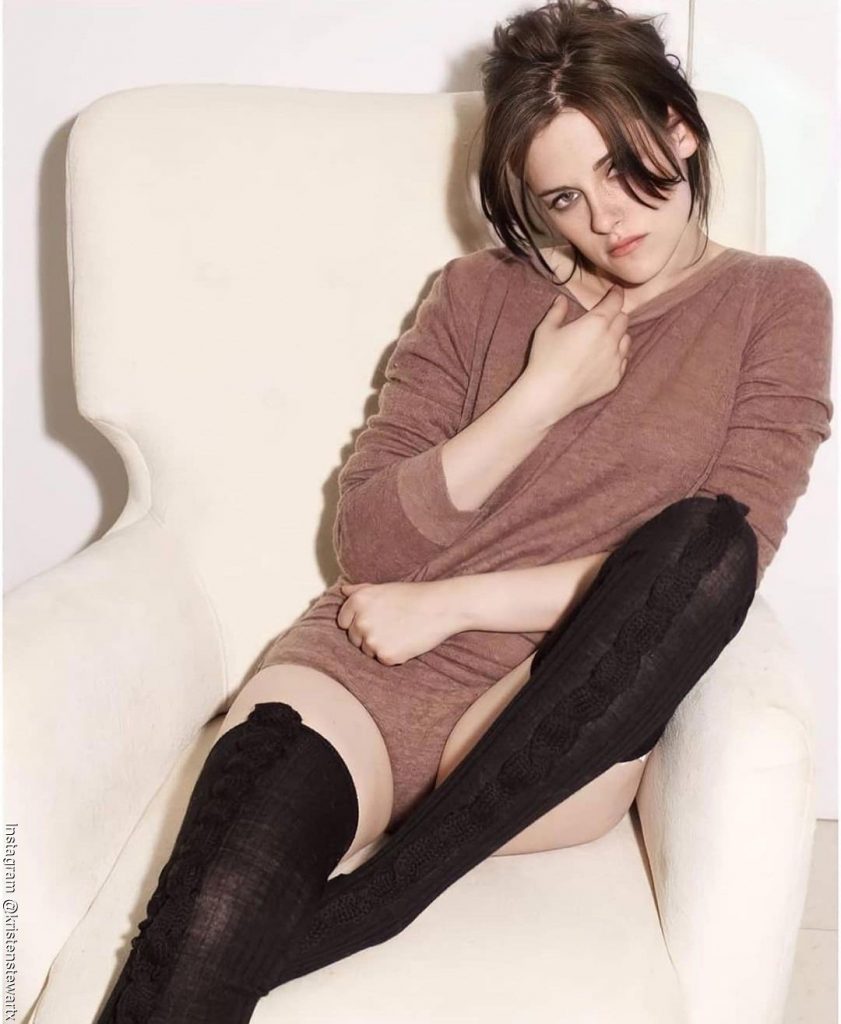 Foto de Kristen Steward  sentada con un vestido café