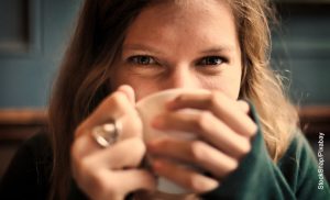 Foto de una mujer tomando una bebida que ilustra cómo desintoxicar el hígado