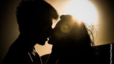 Foto de una pareja besándose en el campo que muestra las frases de películas de amor