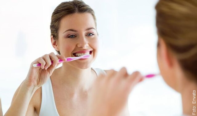 foto de mujer cepillándose los dientes para quitar el mal aliento