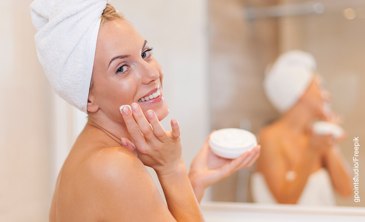 Foto de una mujer usando una crema en la piel que ilustra el serum vitamina C