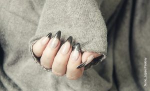 Foto de la mano de una mujer que muestra las úñas en resina