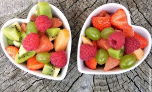 Foto de dos tazos en forma de corazón con fruta que muestra lo que significa soñar con frutas