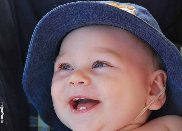 Foto de un bebé que ríe y muestra sus dientes