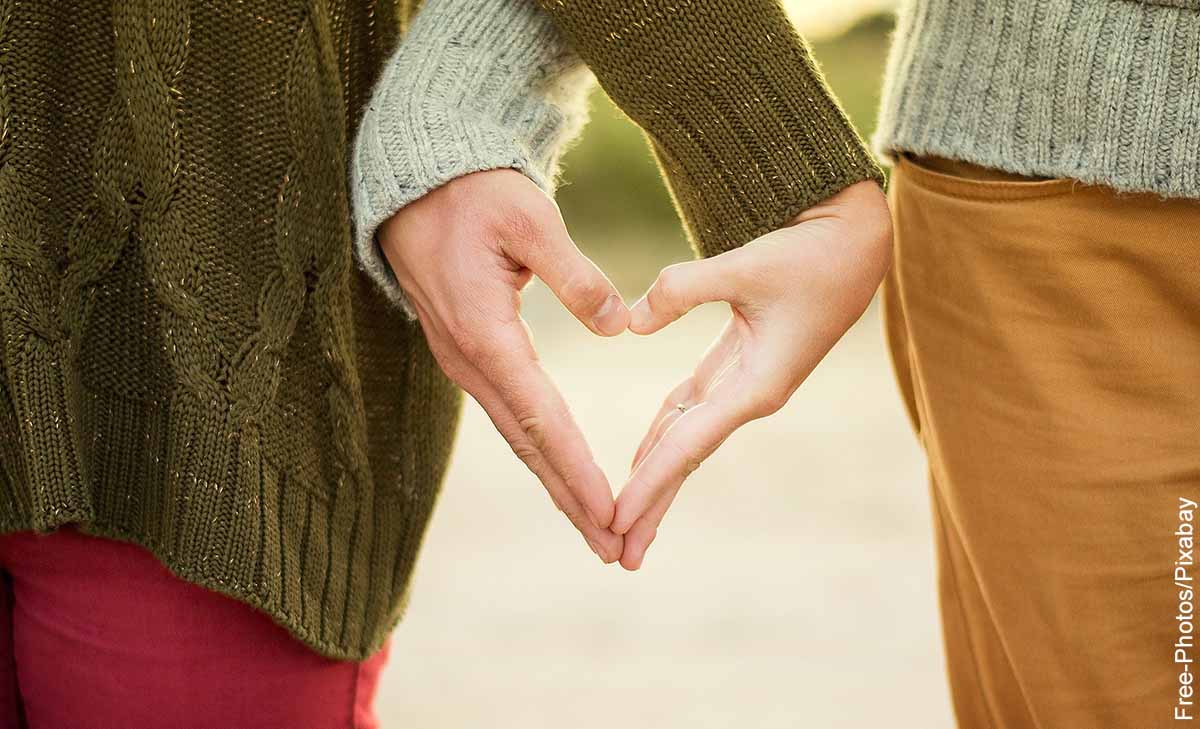 Foto de una pareja formando un corazón con sus manos que revela qué significa crush
