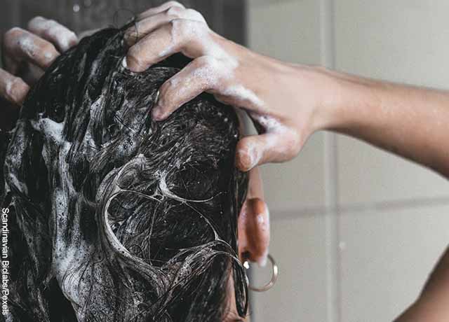 Foto de una mujer lavando su pelo que muestra los masajes para el cabello
