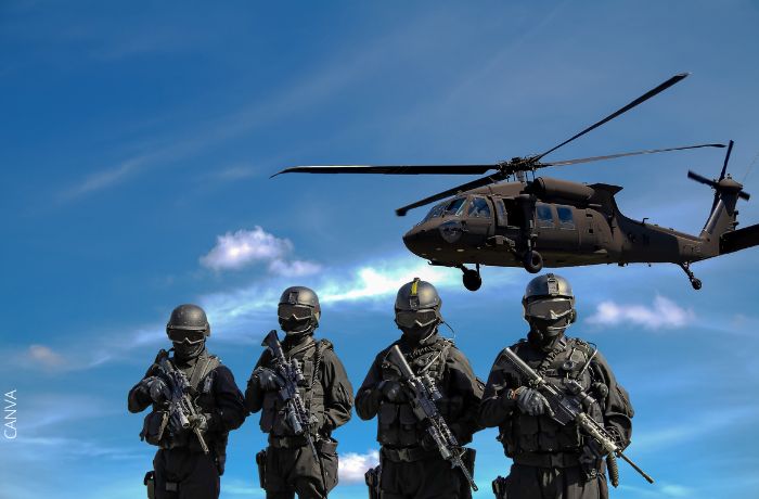 Foto de soldados con un helicóptero volando detrás