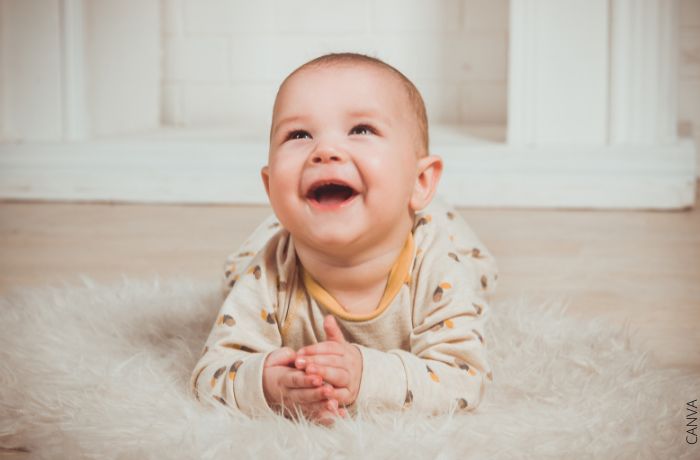 Foto de un bebé riendo y mirando hacia arriba