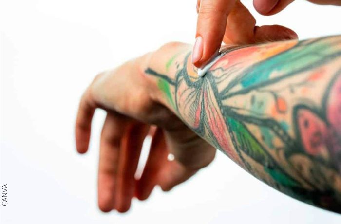 Foto de una persona aplicando crema en un tatuaje