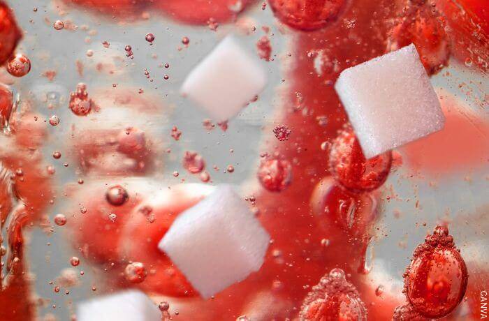 Ilustración con burbujas rojas y cubos de azúcar
