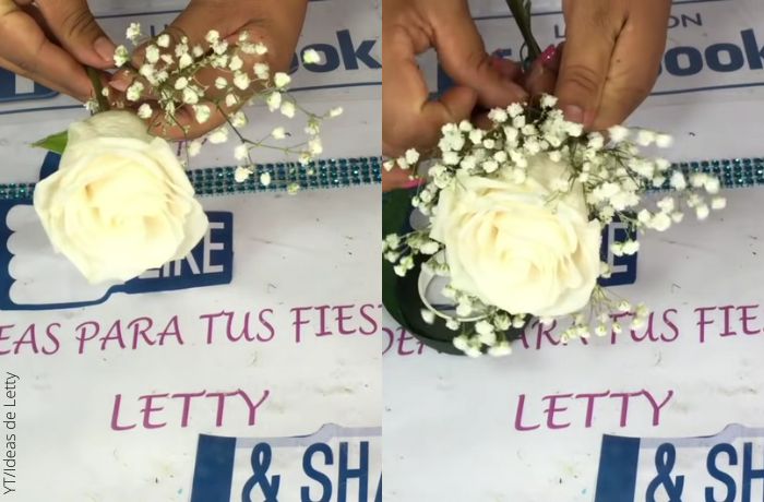 Foto de una mano adornando una rosa blanca
