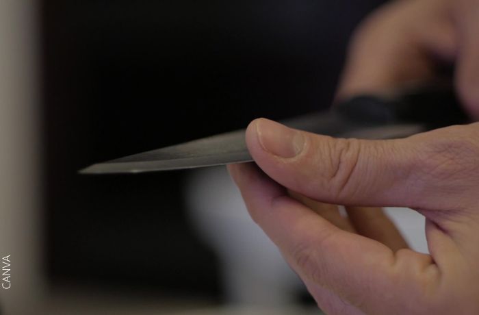 Foto de un dedo pasando por el filo de un cuchillo