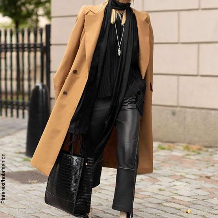 foto de una mujer con outfit total black y abrigo café