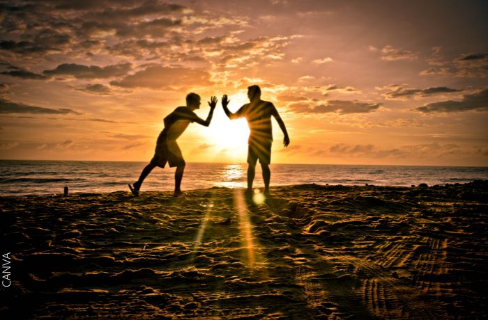 Foto de la silueta de dos amigos en la playa